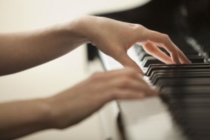 young woman hands playing piano