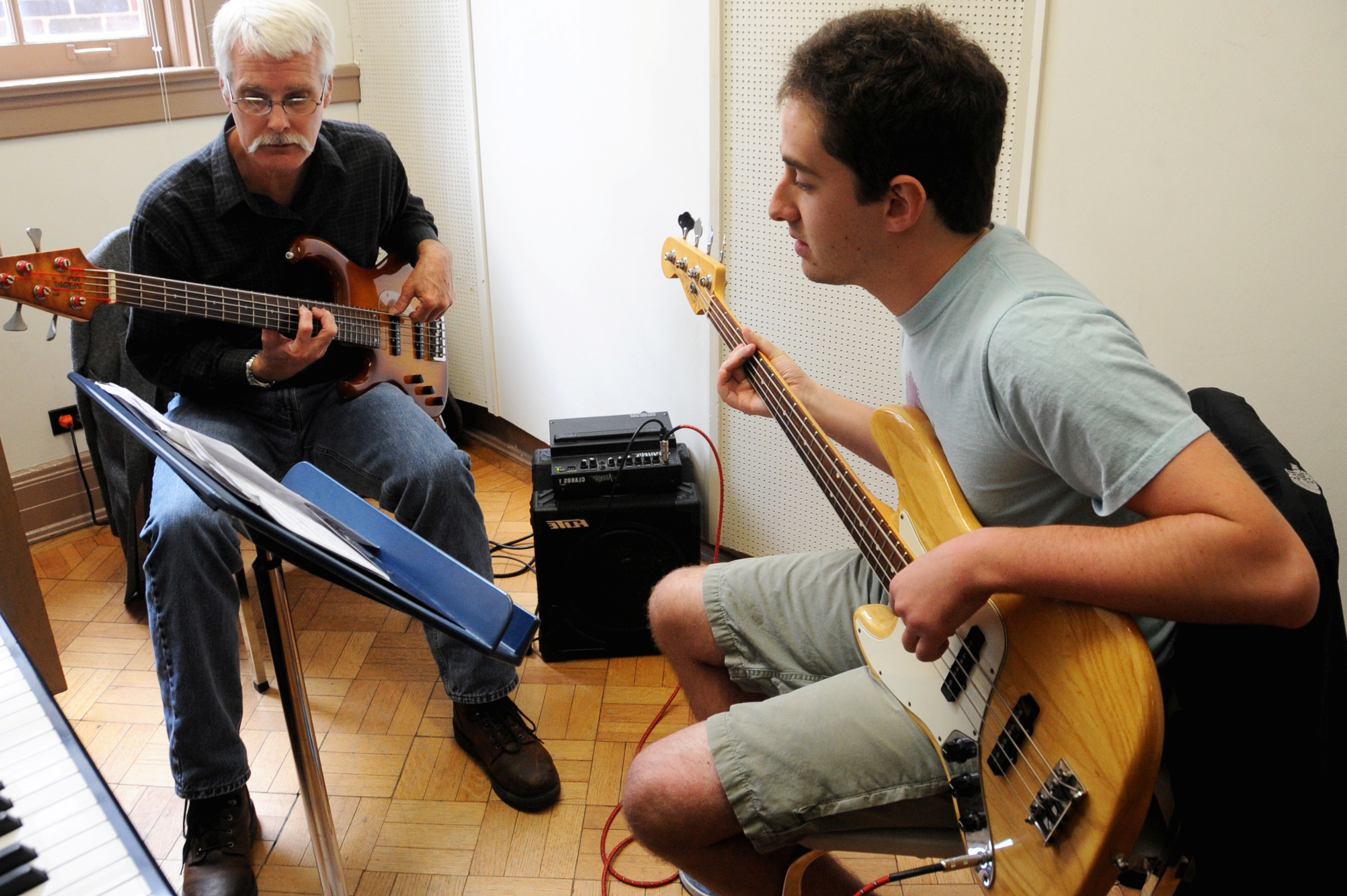 two people playing guitar